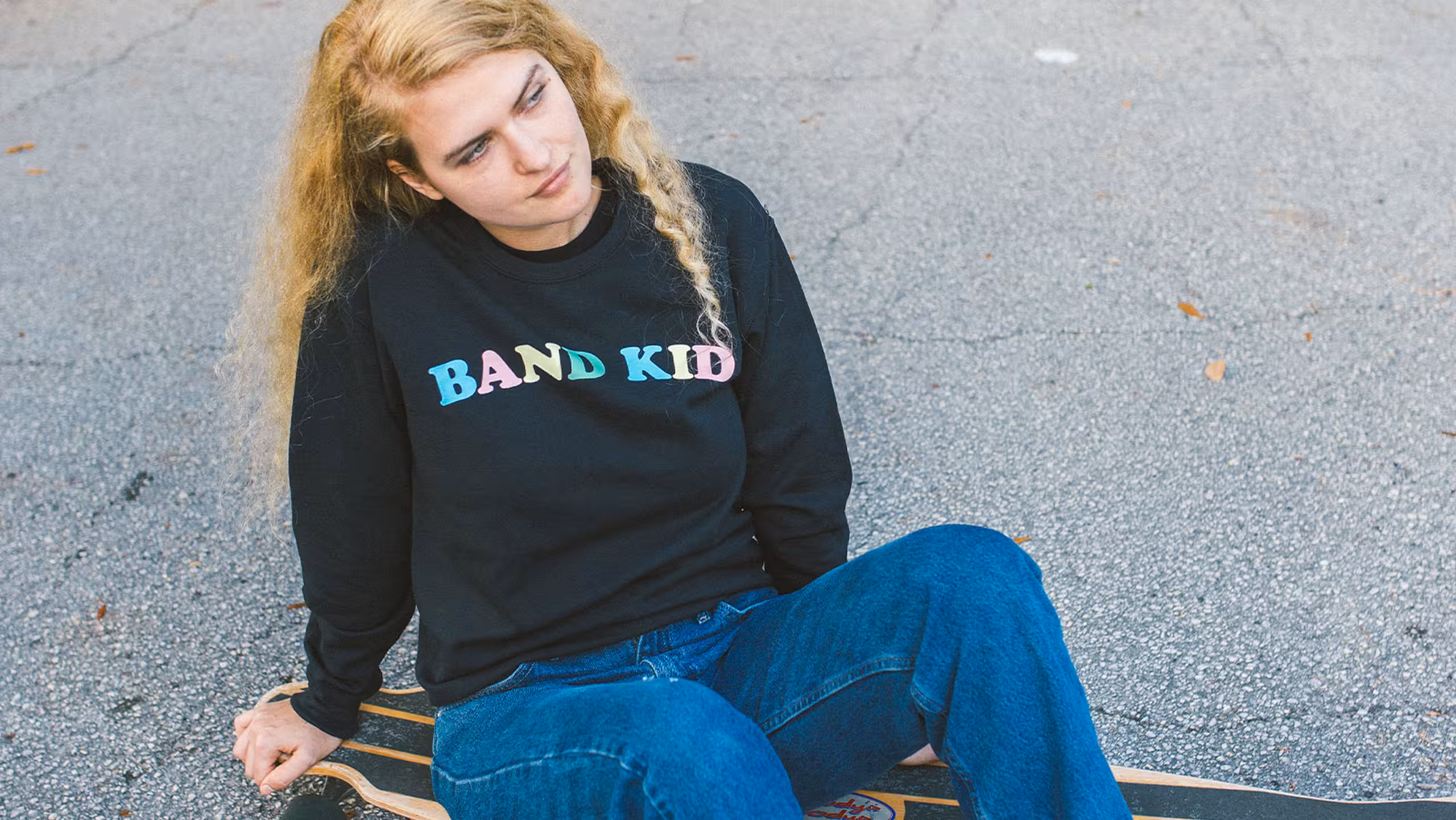 Women wearing a black sweatshirt that said, "Band Kid."
