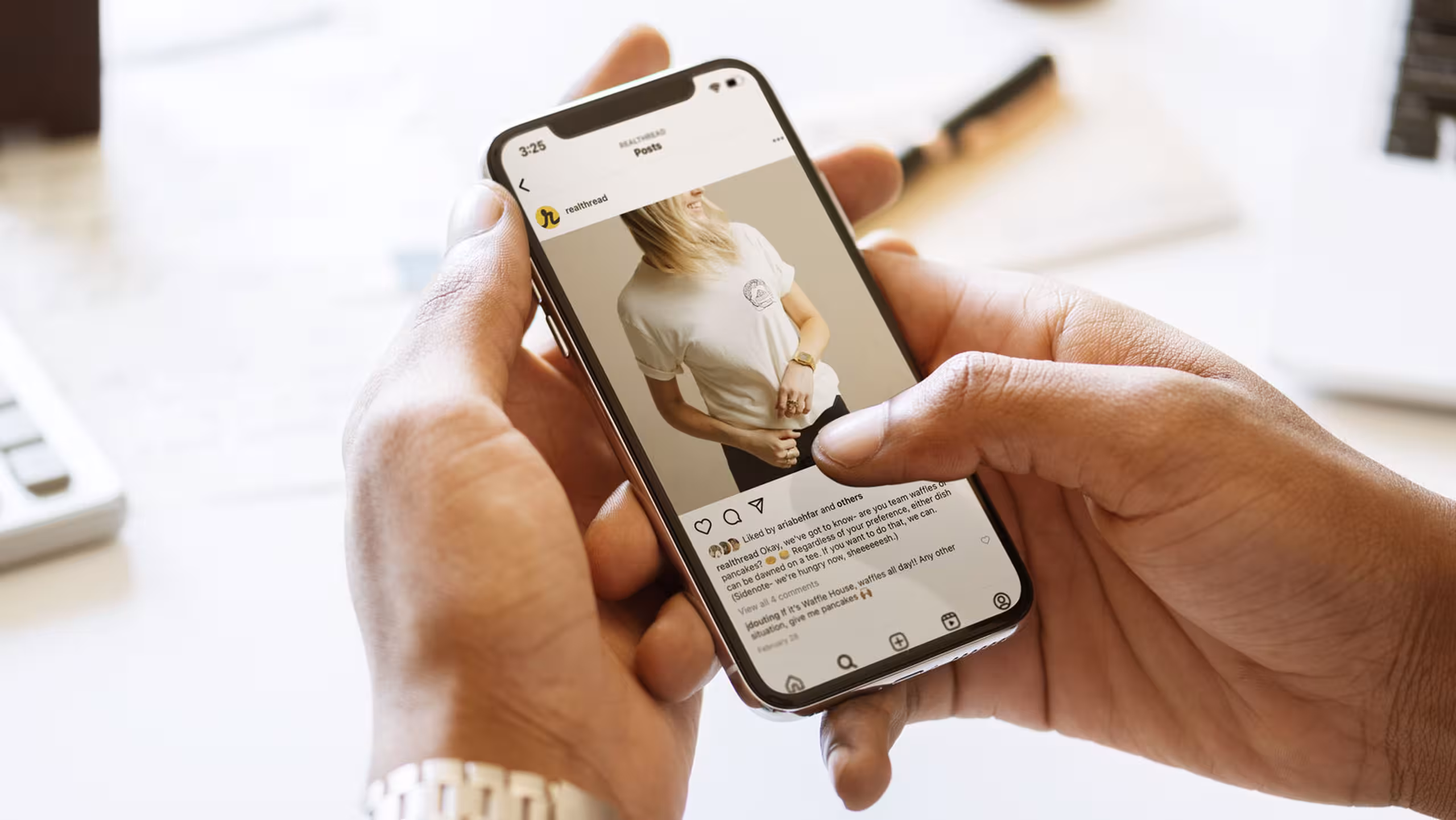 hands holding an iPhone with Real Thread's Instagram post on it.