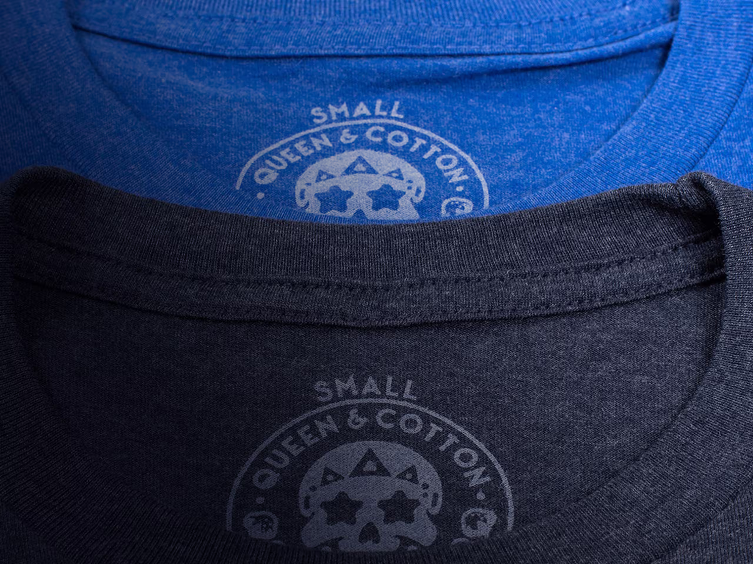 close up of two printed tags on a blue and grey t-shirt