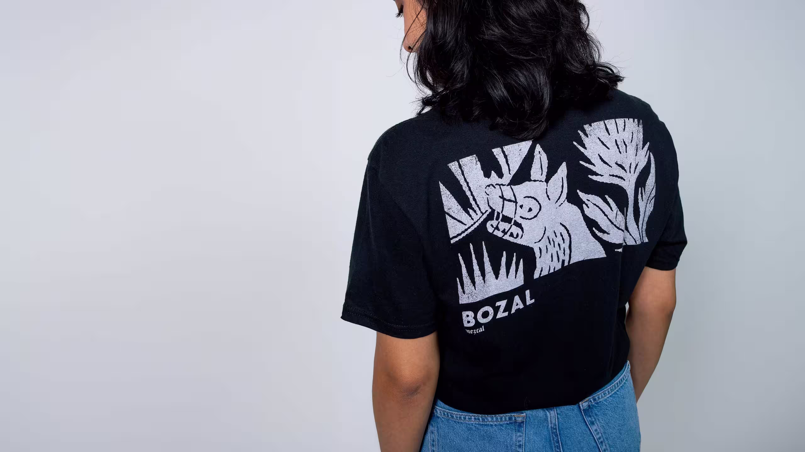 the back of a women wearing a black t-shirt
