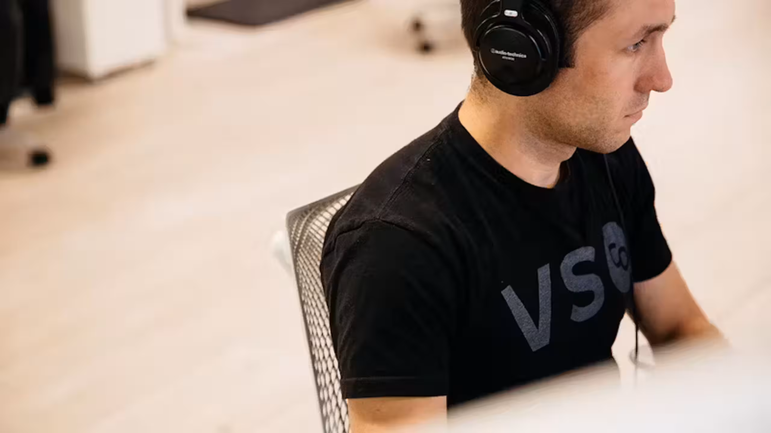 man sitting at a desk with headphones on