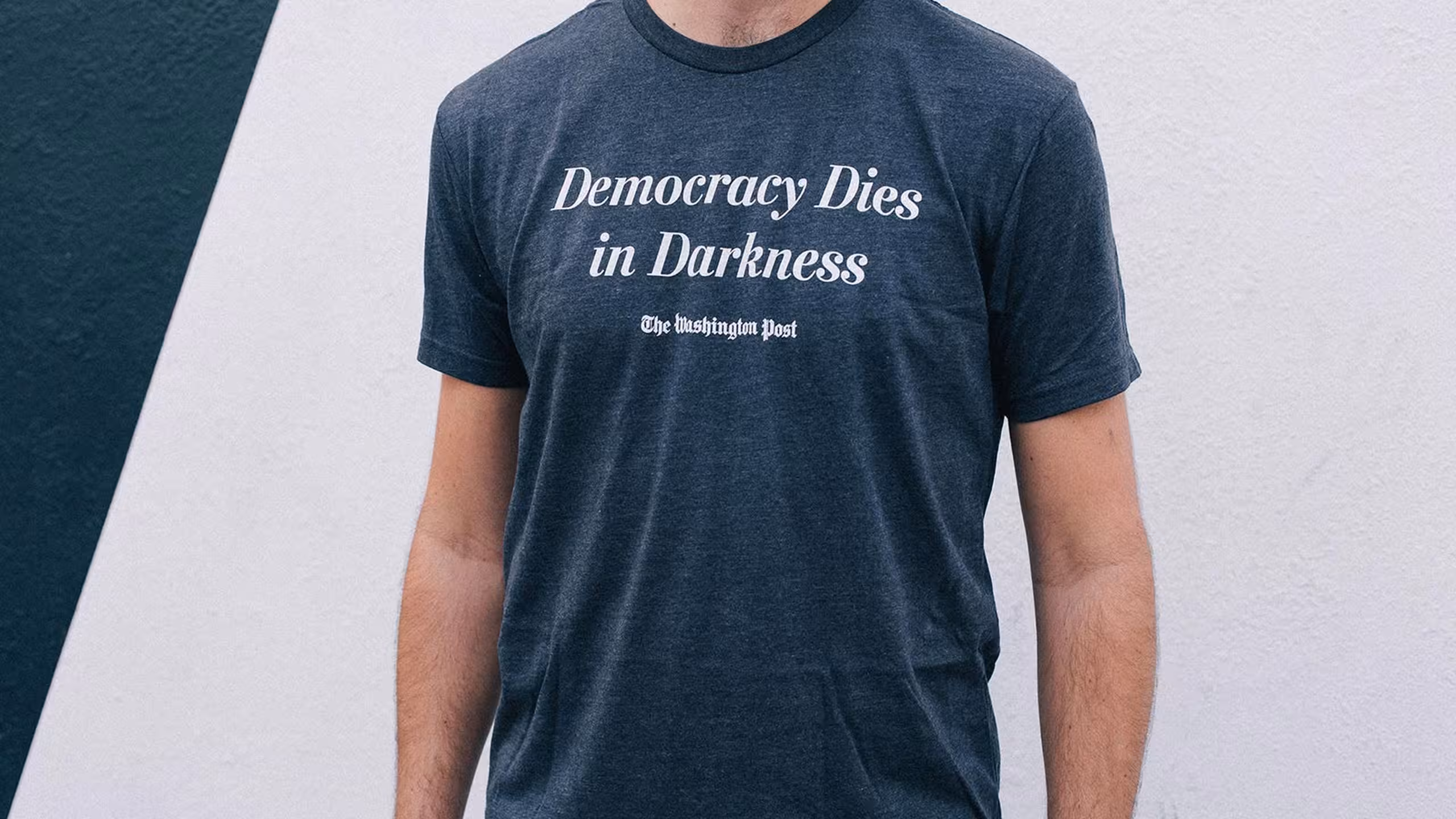 someone wearing a washington post t-shirt that saids - democracy dies in darkness