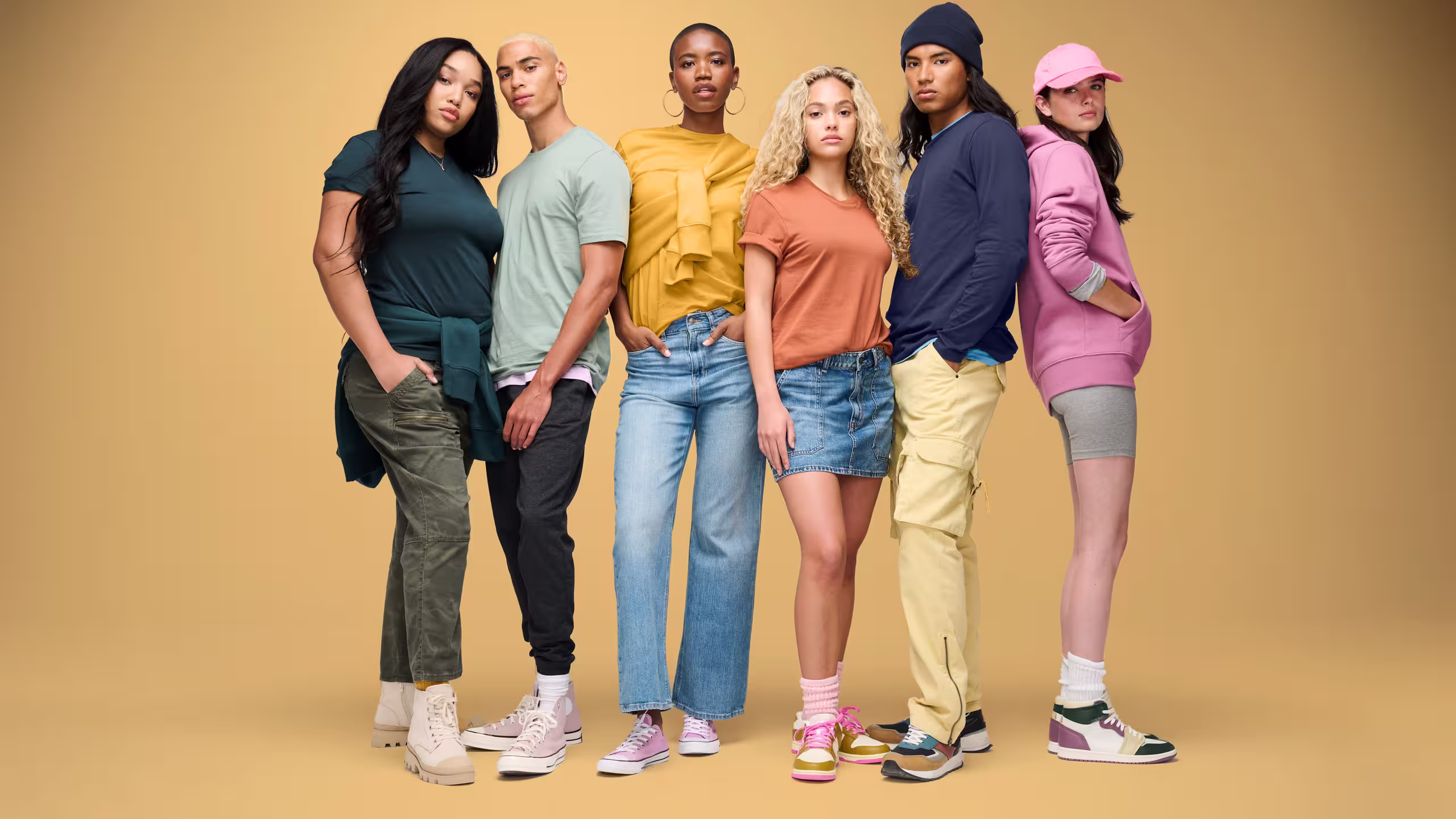 group of five people with different colors shirts and hoodies