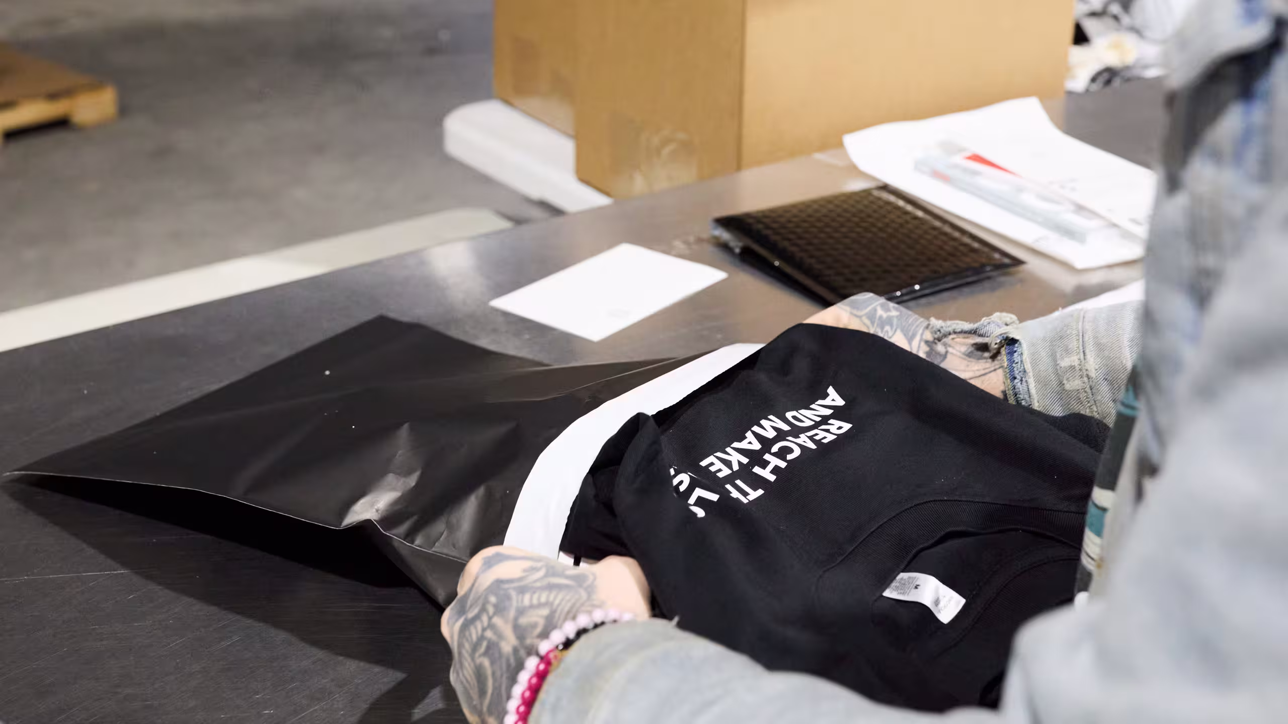 someone bagging a shirt to ship