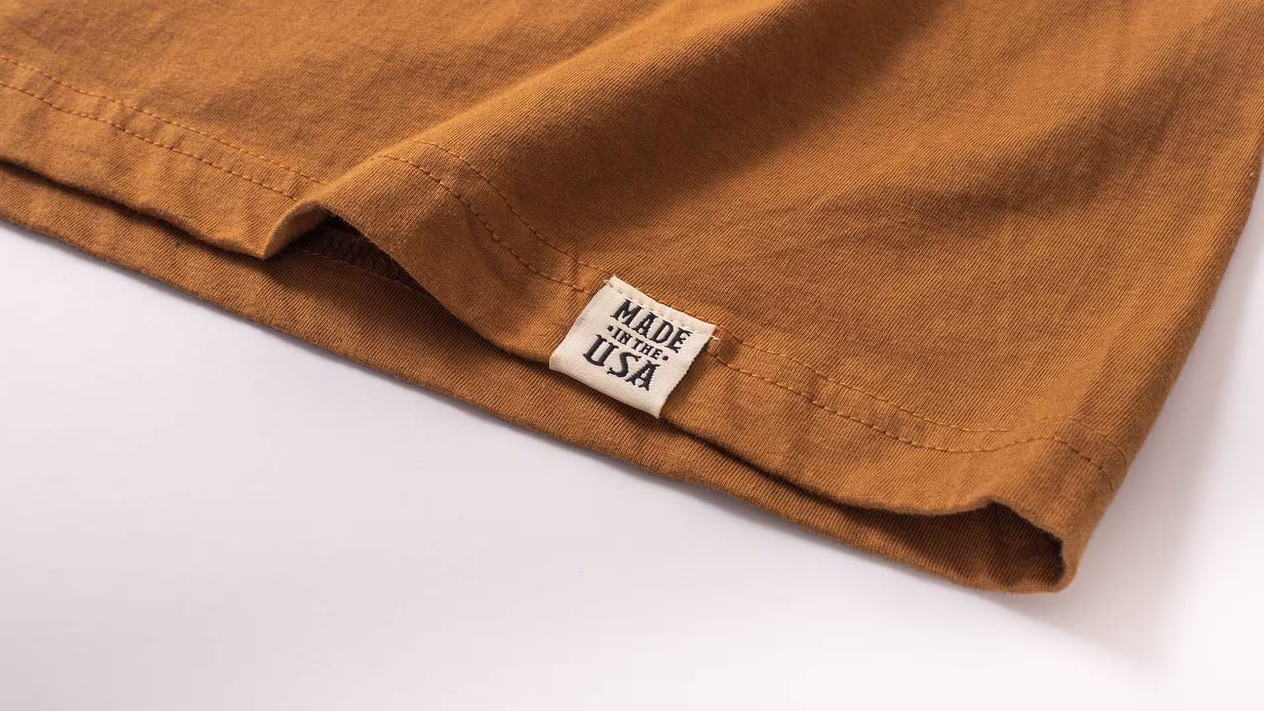 close up view of a hem tag on a copper t-shirt