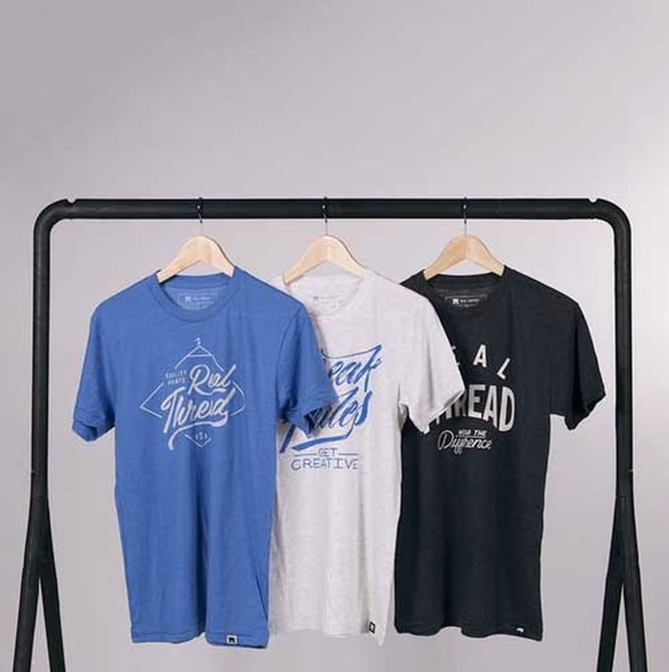 three shirts hanging, blue - white- black