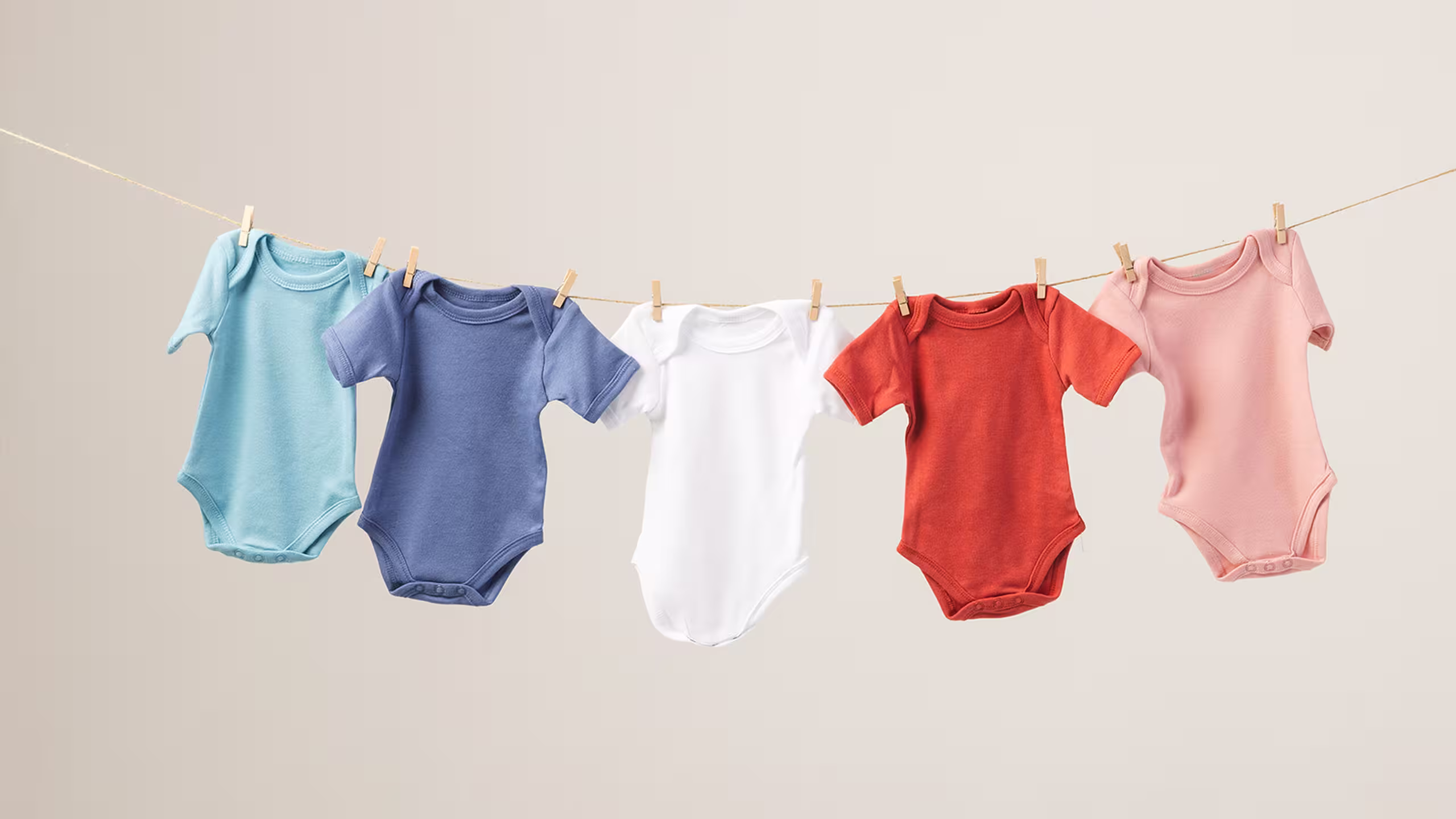 baby onesies hanging on a clothes line